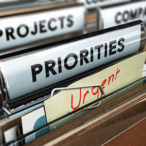 Close up of name tags on file folders indicating priorities.